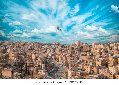 Jordan Flag In Amman, Landscape View Of Cloudy Sky Background 