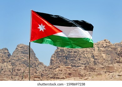 Jordan Flag And Tourist Visiting Petra Unesco Heritage Site 