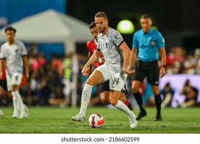 Jordan Henderson #14(white) of Liverpool battles for possession with Bruno Fernandes of Manchester Utd during the Match Manchester Utd and Liverpool at Rajamangala Stadium on July12 2022, BKK Thailand