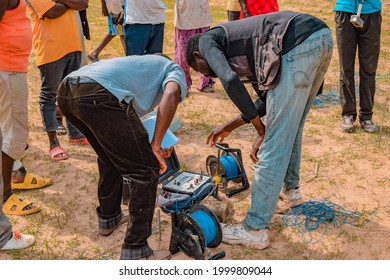 Jos East, Plateau State - May 12, 2021: African Geologist And Team Members Conducting Geophysical Survey For Water Availability In The Ground. Soil Science. Rural Water Project.