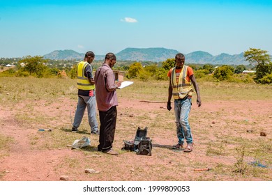 Jos East, Plateau State - May 12, 2021: African Geologist And Team Members Conducting Geophysical Survey For Water Availability In The Ground. Soil Science. Rural Water Project.