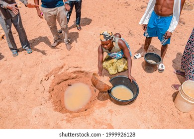 Jos East, Plateau State - May 12, 2021: African Woman Fetching Unclean and Contaminated Water from a Pond or Stream for their Daily Consumption