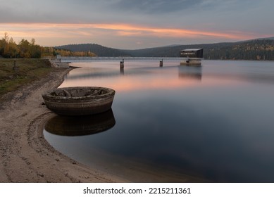 Josefodolska Dam In The Jizera Mountains In The Evening Light. Water Overflow In The Foreground, Bridge In The Background And Red Sky.