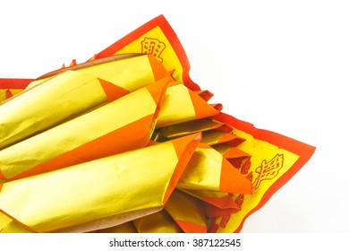 Joss Paper Isolated on white, selective focus. Joss paper are sheets of paper that are burned in traditional Chinese (Chinese new year and Qing Ming day - Chinese funeral day)