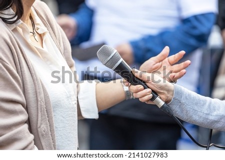 Image, Stock Photo Journalist holding microphone making media interview