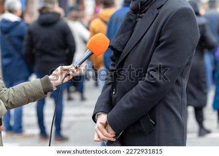 Similar – Image, Stock Photo Journalist holding microphone making media interview