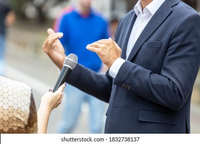 Journalist Making Media Interview With Unrecognizable Person. Vox Populi Concept.