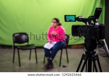 Journalist waiting for the interviewee and practicing speach in a chroma