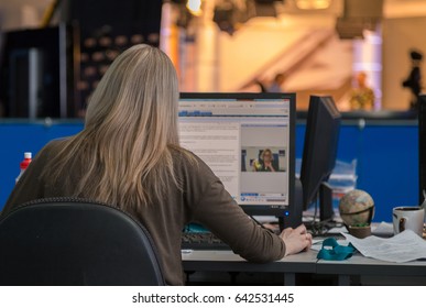 A journalist working on a computer in Newsroom