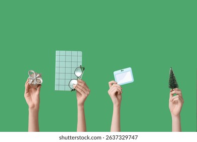 Journalist's female hands with Christmas decorations, notebook and badge on green background - Powered by Shutterstock - Get 15% off with code: PIKWIZARD15