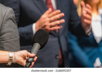 Journalists holding microphone, interviewing politician. - Shutterstock ID 2168392357