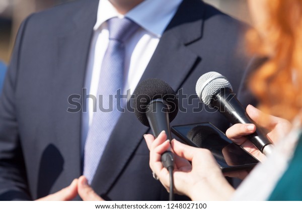 Journalists making media interview with\
business person or\
politician