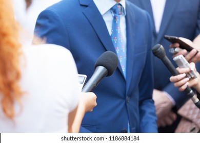 Journalists making media interview with unrecognizable business person or politician - Shutterstock ID 1186884184