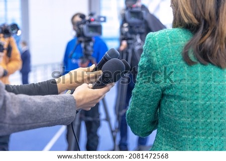 Similar – Image, Stock Photo Journalist holding microphone making media interview