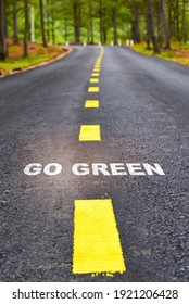 Journey To Go Green On Asphalt Road Surface On Nature Background. Sustainability Development Concept And Future Ahead Idea