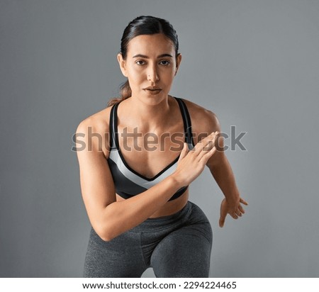 Its a journey, not a sprint, to get in shape. Studio portrait of a sporty young woman running against a grey background.