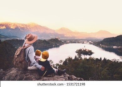 Journey Slovenia with kids. Family travel Europe. Hiker woman with children on Bled Lake among nature and Alps mountains. Traveling mother with backpack with her kids at autumn or winter vacation