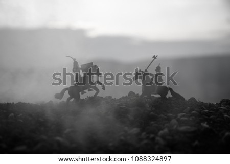 Joust between two knights on horseback. Sunset on background.