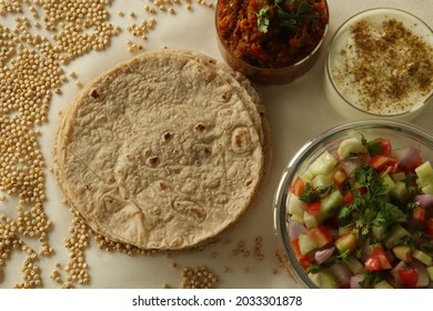 Jowar roti or jowar bhakri are healthy gluten free flatbreads made with sorghum millet flour. Served with mashed and sauteed fire roasted brinjal along with vegetable salad