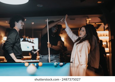 Joy fills the air as friends celebrate a successful pool shot at a lively bar. Their evening out is captured in smiles, laughter, and high fives. - Powered by Shutterstock