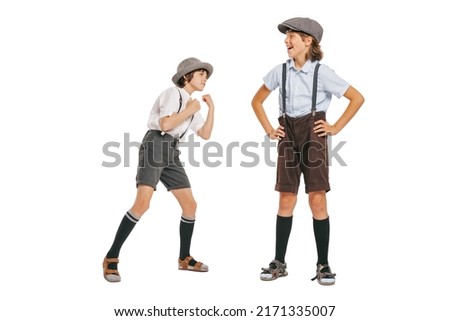 Joy, fun. Cheerful little boys, stylish kids wearing retro clothes posing isolated over white background. Concept of childhood, vintage summer fashion style. Copy space for ad