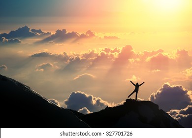 The Joy Of Life. A Person Is Standing On The Top Of The Mountain Above The Clouds. 