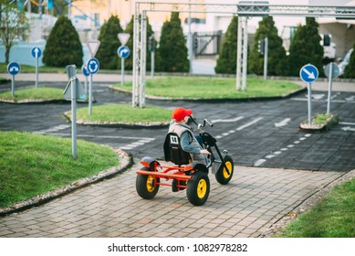 joy small boy is driving toy car on the playground