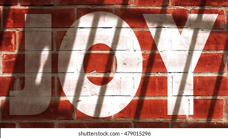 Joy Written On A Wall With Jail Bars Shadow
