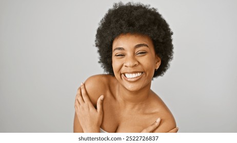 A joyful african american woman with curly hair poses against a white background, embodying beauty and positivity. - Powered by Shutterstock