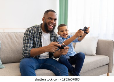 Joyful African Father And Kid Boy Playing Videogames At Home