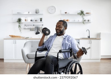 Joyful african person with physical disability holding dumbbells in arms during strength training at home. Active wheelchair user building muscles while experimenting with workout routine. - Powered by Shutterstock