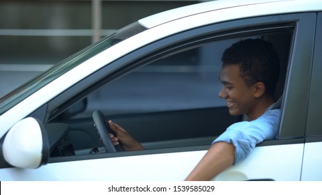 Joyful African-American Teen Boy Sitting On Driver Place, First Car Purchase