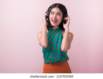 Joyful Asian Woman Wearing Headphone And Listening Music From App In Smartphone.