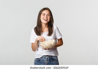 Joyful Attractive Brunette Girl Laughing At Comedy Movie, Eating Popcorn