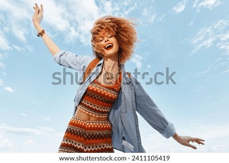 Joyful Beach Adventure: Smiling Woman Dancing with Freedom and Happiness under the Blue Sky