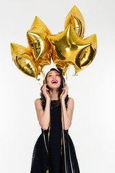 Joyful Beautiful Young Female With Bright Makeup In Retro Style Holding And Looking Up On Star Shaped Balloons