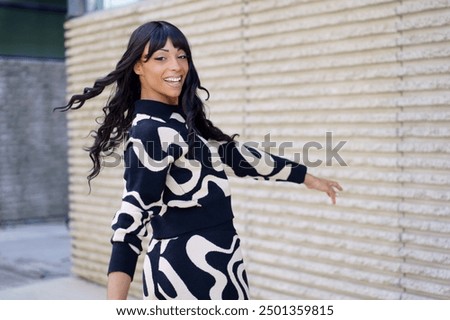 Dancer turning energetically and smiling at camera in the city