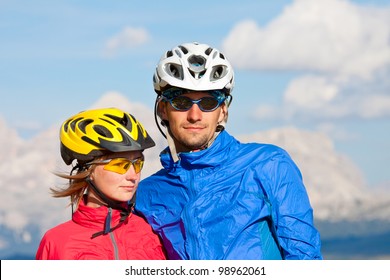 Joyful bikers couple enjoying a mountains view