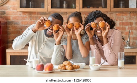 Joyful Black Family Having Fun During Breakfast At Kitchen, Making Cupcake Eyes, Panorama