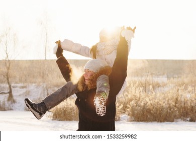 Joyful Brother And Sister Spend Time Together On A Walk In The Winter Park On A Sunny Day. Having Fun Playing In Snow Outdoors. Winter Best Time For Cheery