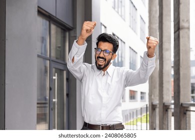 A joyful businessman dances from the outside of the office building, a satisfied man celebrates the victory of Triumph. - Powered by Shutterstock