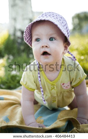 small girl wearing a hat singing happily