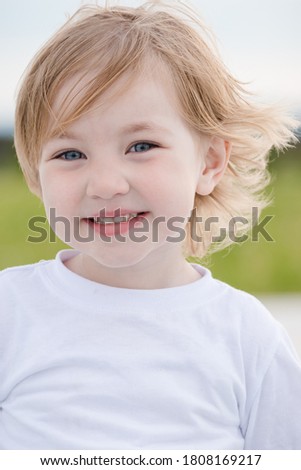 Similar – Small child with long blond hair enjoying of a sunny day