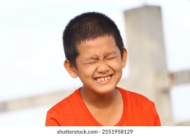 A joyful child laughs heartily, showcasing pure happiness in an outdoor setting. The bright, natural light highlights the carefree spirit and youthful energy. - Powered by Shutterstock