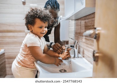 Joyful child learns handwashing in a cozy bathroom setting - Powered by Shutterstock