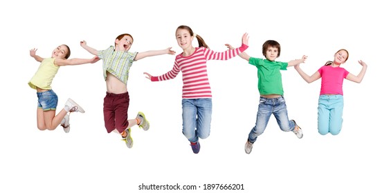 Joyful Children Jumping In Mid-Air Posing And Having Fun Over White Studio Background. Kids Group In Casual Clothes Jump In A Row. Carefree Childhood. Collage, Panorama