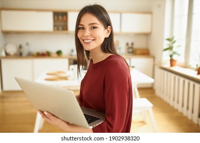 Joyful Confident Young Woman Smm Manager Working Distantly From Home Using Wireless Internet Connection On Generic Laptop, Making Content For Social Media Account, Advertising Product Or Service