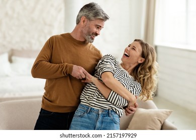 Joyful Couple Dancing Having Fun At Home. Loving Husband And Wife Having Date Hugging And Laughing Indoors. Romantic Relationship And Happy Marriage Concept - Shutterstock ID 2157197929