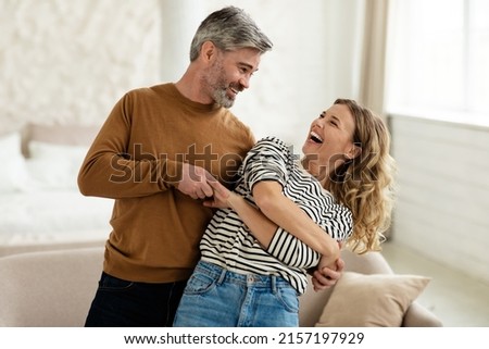 Joyful Couple Dancing Having Fun At Home. Loving Husband And Wife Having Date Hugging And Laughing Indoors. Romantic Relationship And Happy Marriage Concept
