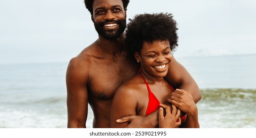 A joyful couple embraces on a sunny beach, radiating happiness and relaxation. The man and woman, both in swimwear, are enjoying a carefree day by the ocean. The essence of a perfect summer getaway. - Powered by Shutterstock